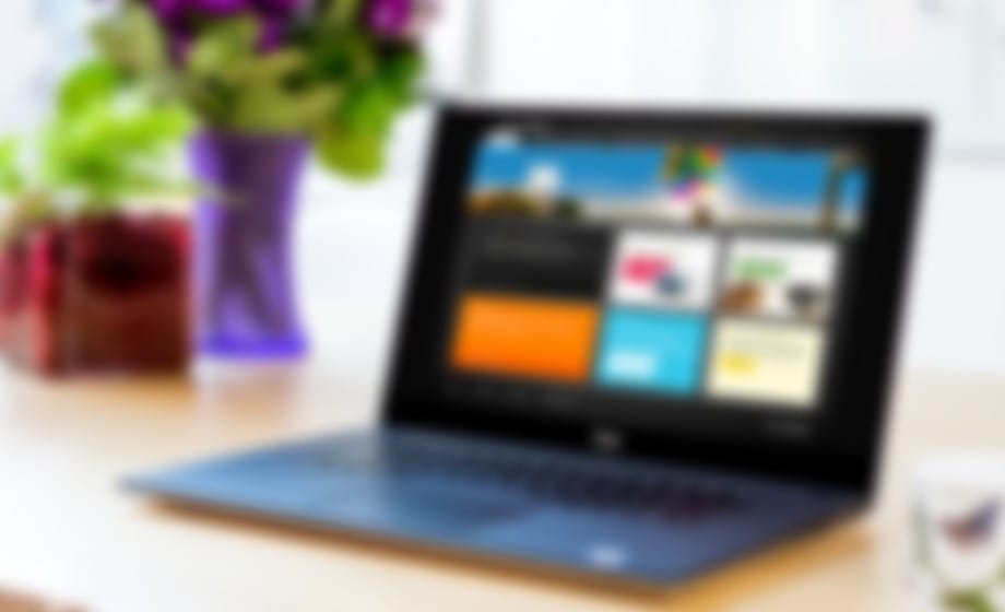 Laptop showing a trade portal with coloured content tiles