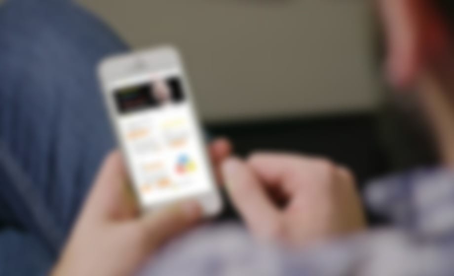 Hand holding a phone showing a campaign website home screen