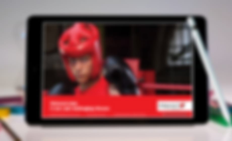 Tablet with a stylus showing a video of a person wearing a red cycling helmet