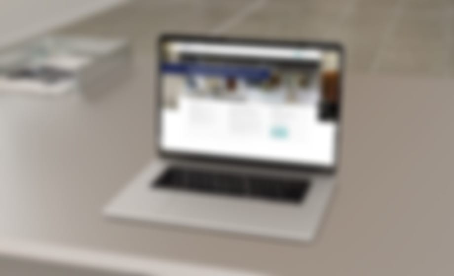 Laptop on a desk showing a hospital website home page